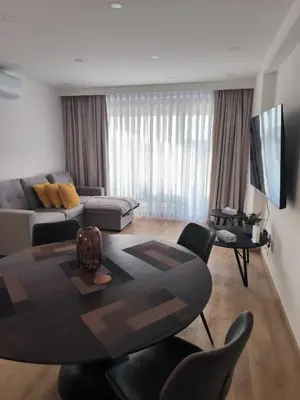 a living room with a table and a couch at 2 Bedroom Brand New Apartment Mc Kenzie 2 minute to the Mc Kenzie Beach in Larnaka