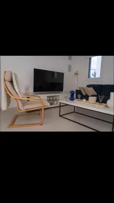 a living room with a chair and a tv at MERAKI Villa in Paralimni