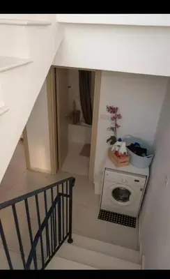a staircase with a washing machine in a room at MERAKI Villa in Paralimni