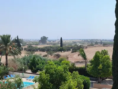a view of a resort with a pool and trees at Superior 1 bed apartment in Oroklini with Communal Pool in Voroklini