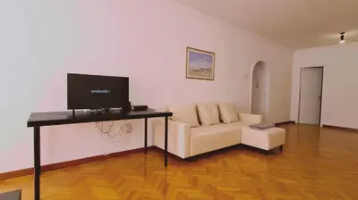 a living room with a couch and a television on a table at STAY Virtuoso Apartment in Nicosia