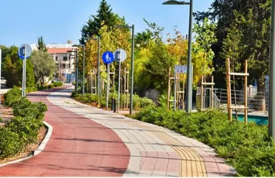 a walkway in a park next to a pool at RIVERA Studios 1 in Limassol