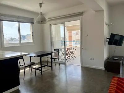 a dining room with a table and chairs and a balcony at The Comfort Stay in Nicosia Verenikis - Platform 357 in Nicosia