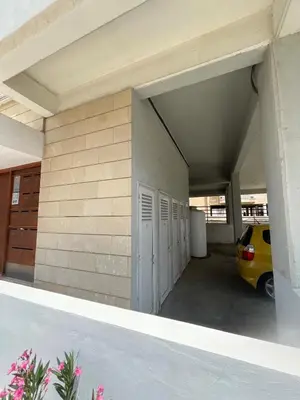 a parking garage with a yellow car parked in it at The Comfort Stay in Nicosia Verenikis - Platform 357 in Nicosia