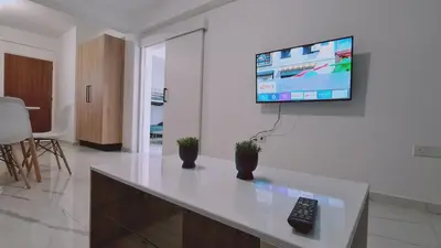 a living room with a tv on a wall at STAY Azure Dream Apartment in Paralimni