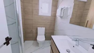 a bathroom with a toilet and a sink and a shower at STAY Azure Dream Apartment in Paralimni