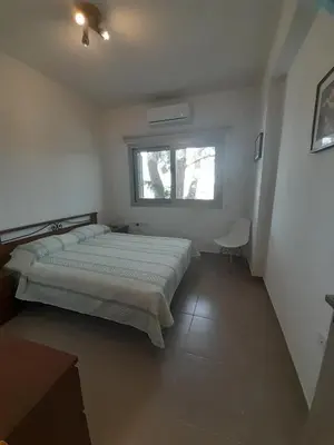 a bedroom with a bed and a window at Olive & Pinetree House in Lythrodontas