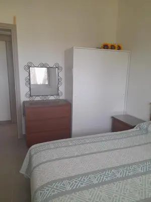 a bedroom with a bed and a mirror on a dresser at Olive & Pinetree House in Lythrodontas