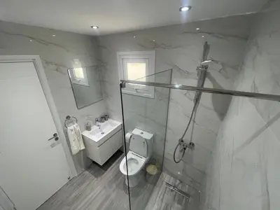 a bathroom with a shower and a toilet and a sink at Green Bay Cosy Escape in Protaras