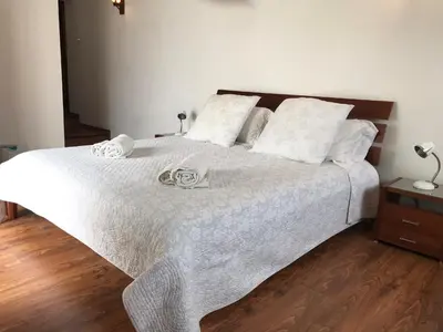a white bed with two towels on top of it at Cobblers in Maroni