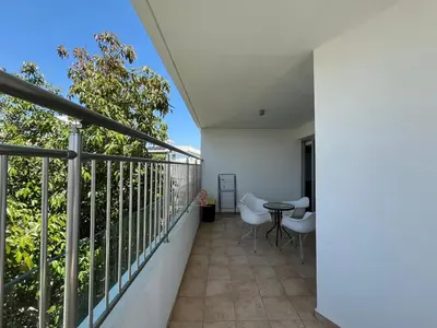 a balcony with a table and chairs on it at Cozy Stay Nicosia in Nicosia