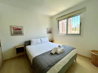 a bedroom with a bed with two towels on it at Cozy Stay Nicosia in Nicosia