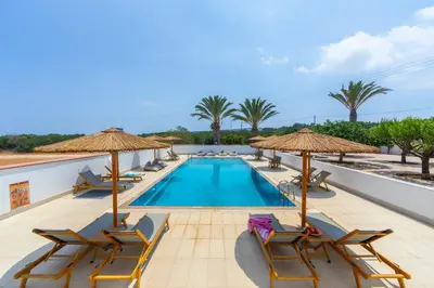 a swimming pool with lounge chairs and umbrellas at Protaras Views Villa PRAM1 in Protaras