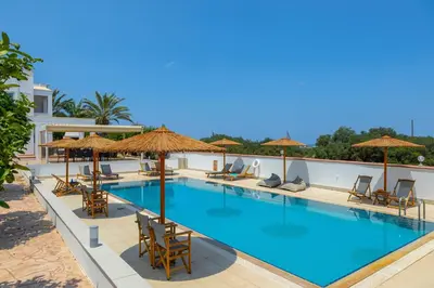 a swimming pool with chairs and umbrellas at Protaras Views Villa PRAM1 in Protaras