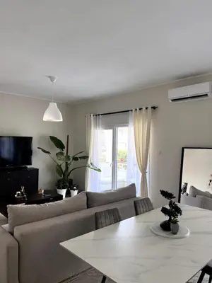a living room with a couch and a table at Casi-Homes in Larnaka