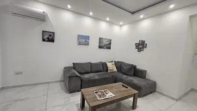 a living room with a couch and a coffee table at STAY Finibreeze Apartment in Larnaka
