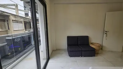 a chair sitting in a room next to a window at STAY Finibreeze Apartment in Larnaka