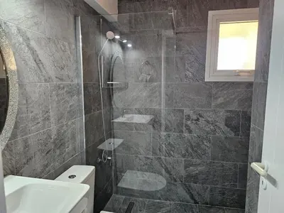 a bathroom with a shower and a sink and a toilet at Kapparis - Blue and aqua in Paralimni