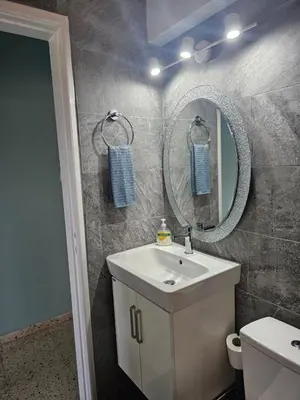 a bathroom with a sink and a mirror at Kapparis - Blue and aqua in Paralimni