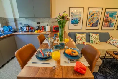 a dining room table with glasses of orange juice on it at 1 BDR New Boutique & Prime Location in Limassol