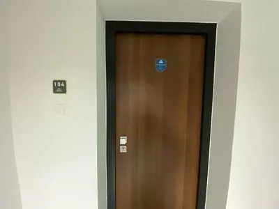 a brown door with a sign on it in a hallway at 1 bedroom 104 in Limassol