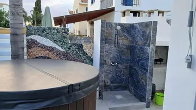 a shower in the backyard of a house at Villa Elia Blue , hot tube , heated pool in Paralimni