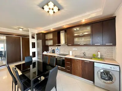 a kitchen with a table and a sink and a dishwasher at Sunny Stay 2 Bdr near the sea Platform 357 in Limassol