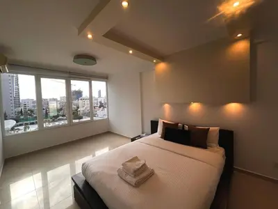 a bedroom with a large bed with two towels on it at Sunny Stay 2 Bdr near the sea Platform 357 in Limassol