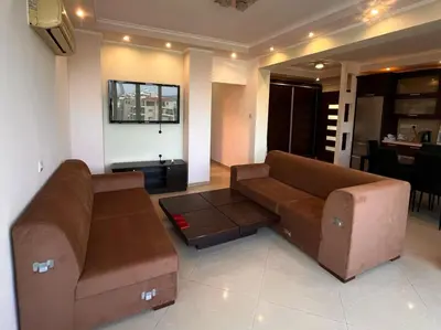 a living room with a brown couch and a table at Sunny Stay 2 Bdr near the sea Platform 357 in Limassol