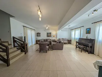 a living room with a couch and a piano at Fig Tree Bay Villa Elena in Protaras