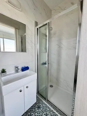 a bathroom with a shower and a sink at Villa Jarvis Modern and Quiet 3BR with Private Swimming Pool in Paralimni
