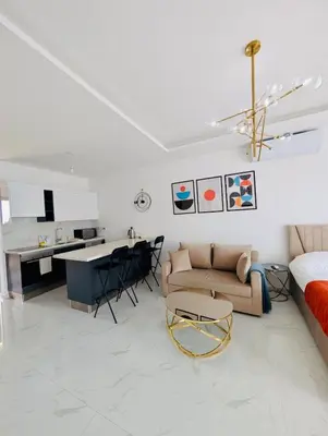 a white living room with a couch and a table at Modern Luxury Apartment in Aglantzia