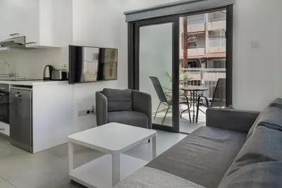 a living room with a couch and a table at Seabreeze Residence by Staycom in Larnaka