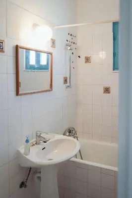a white bathroom with a sink and a bath tub at L'Azure 24 - Protaras in Paralimni
