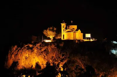 a building on top of a hill at night at Mediterraneo 27 - Protaras in Protaras