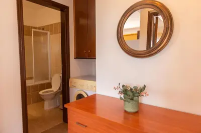 a bathroom with a toilet and a mirror on the wall at STAY Kali Sun Apartment in Paralimni