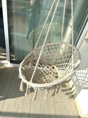 a white rope swing sitting on a porch at Serene Getaway Near Protaras in Paralimni