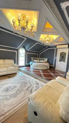 a large room with two beds and a chandelier at Kingdom Villa with Sauna and Hamam in Kaimakli