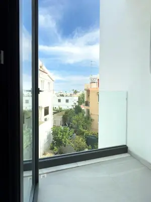 an open window with a view of a city at Sunset Balcony and Espresso Station Apartment in Larnaka