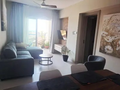 a living room with a couch and a table at Sea View Floral Suite - 2 bedroom in Larnaka