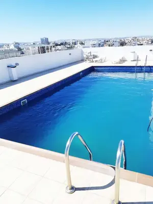 a swimming pool on the roof of a building at Sea View Floral Suite - 2 bedroom in Larnaka