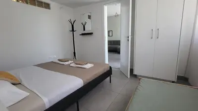 a bedroom with a bed with two towels on it at Hanapartment 3 bed Ayia NAPA in Ayia Napa
