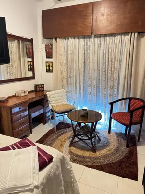 a living room with a desk and a table at 2 bedroom apartment 50 meters from the sea in Limassol