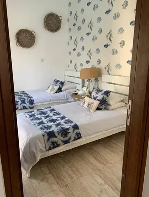 two beds in a room with blue and white at Elysian Villa in Larnaka