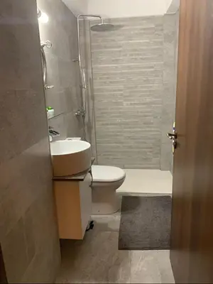 a bathroom with a toilet and a sink and a shower at Elysian Villa in Larnaka