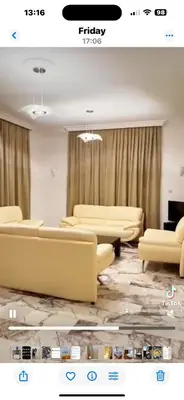 a living room with couches and tables and curtains at Heritage Villas Northern Cyprus in Mağusa