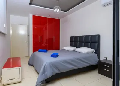 a bedroom with a bed and a red closet at City Center Flat 23 in Larnaka