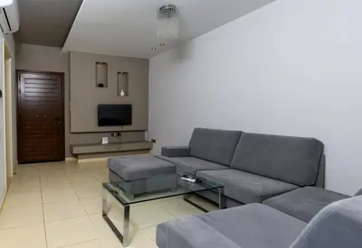 a living room with a couch and a table at City Center Flat 23 in Larnaka