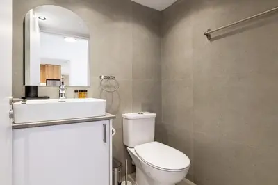 a bathroom with a toilet and a sink and a mirror at Finikoudes Marina View 102 in Larnaka