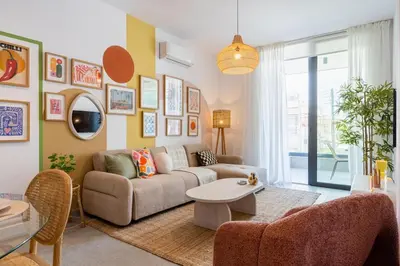 a living room with a couch and a table at Lunette - Artful 1-BR Apartment & Balcony in Larnaca in Larnaka